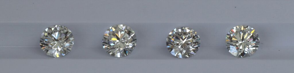 Four Round Diamonds, varying color grades from "G" to "J"