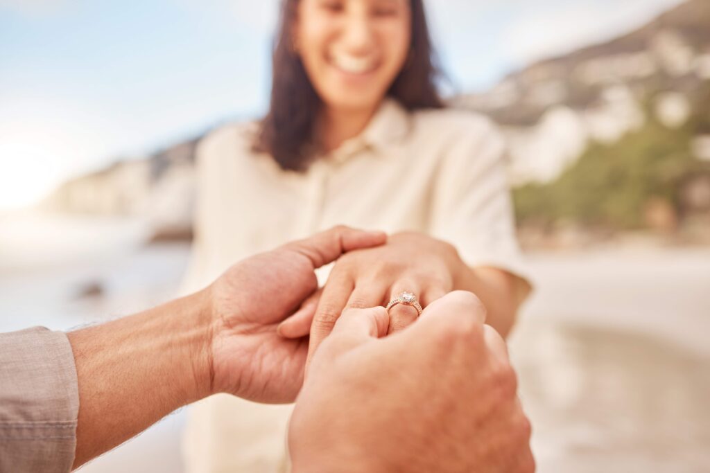 Women being proposed to with engagement ring on the left hand 4th finger.